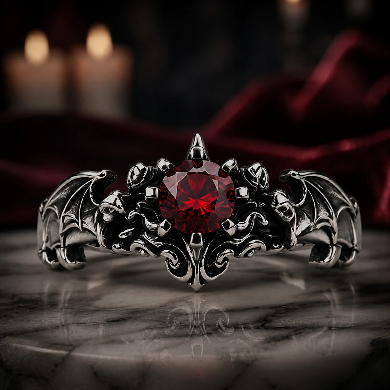 Garnet Bat Wing Ring with a crimson center and sculpted bat wings